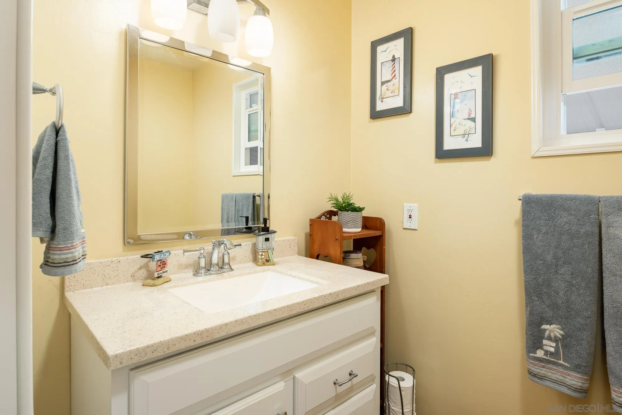 262 Brookside Lane Oceanside, CA 92056 - Photo 19 of 43 a bathroom with a sink and a mirror