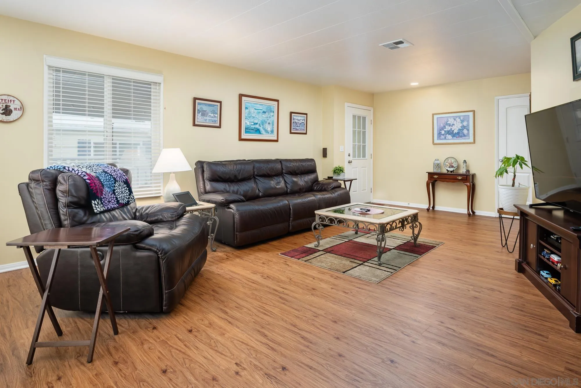 262 Brookside Lane Oceanside, CA 92056 - Photo 9 of 43 a living room with furniture a flat screen tv and a window