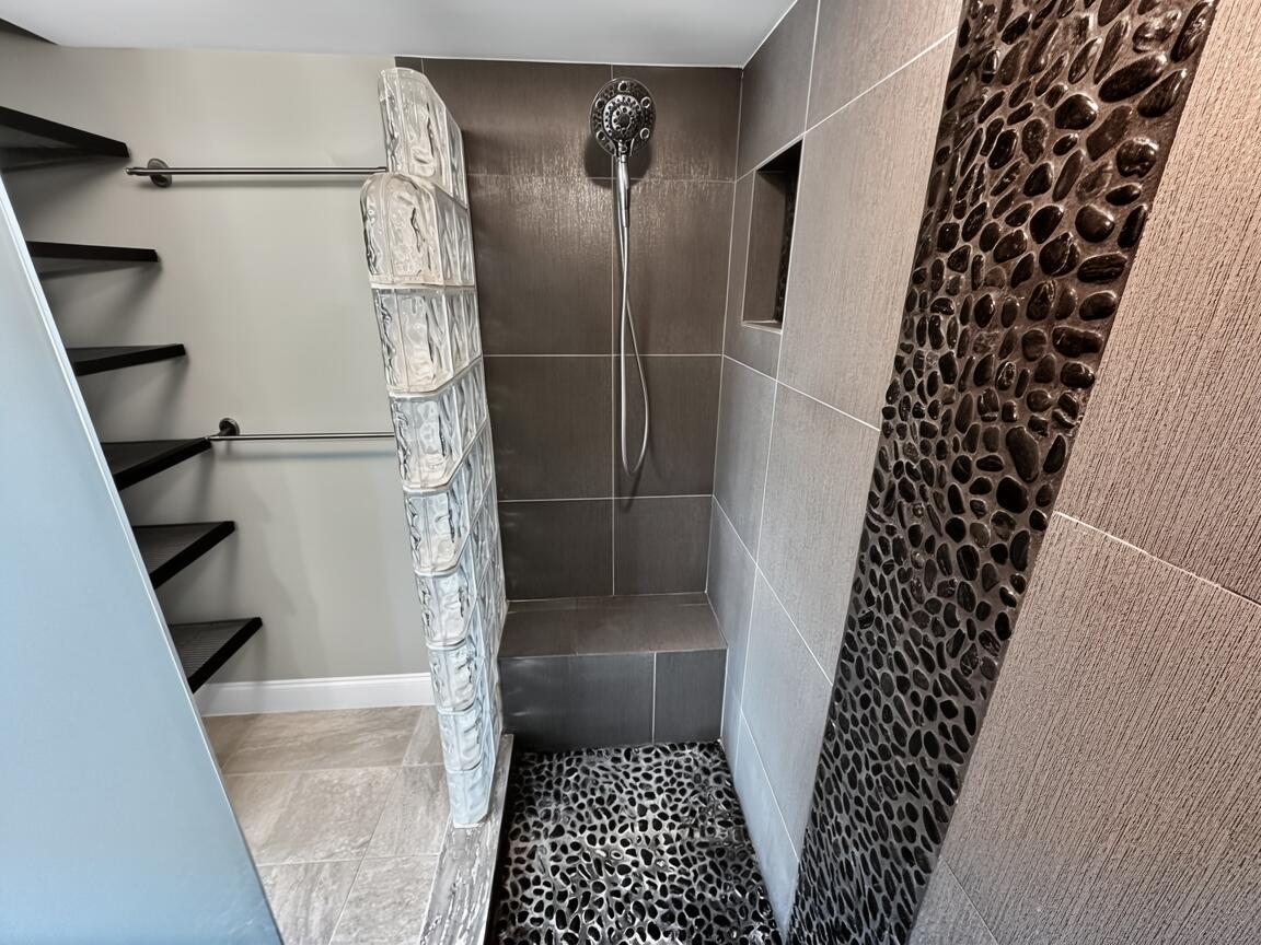 145 Atlantis Boulevard, Unit 302 Atlantis, FL 33462 - Photo 12 of 19 a bathroom with a glass door shower