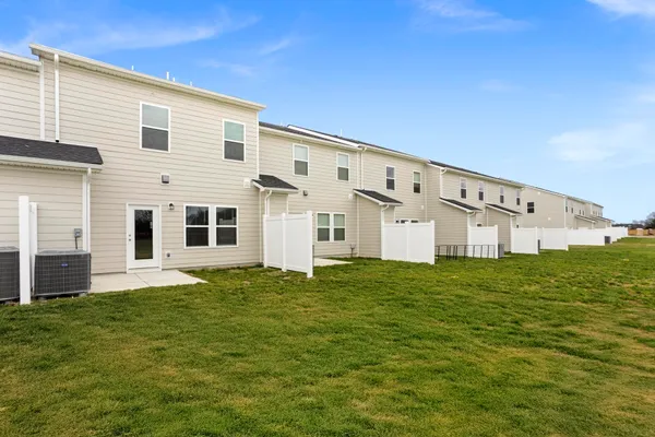 a large white house with a big yard and large trees