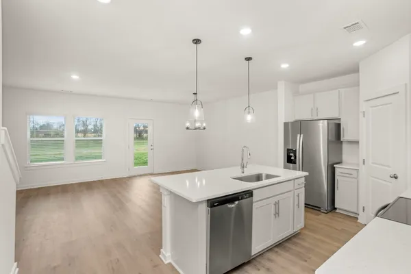 a kitchen with a sink a refrigerator and window