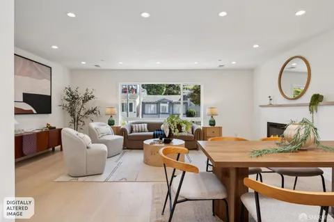 a living room with furniture a fireplace and a potted plant