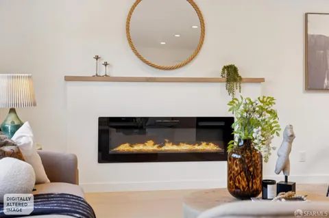 a living room with furniture kitchen view and a flat screen tv