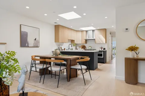 a kitchen with stainless steel appliances a sink a stove a refrigerator cabinets and a counter space