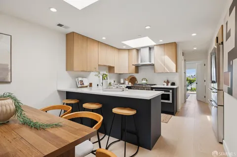a kitchen with stainless steel appliances a stove a sink and cabinets