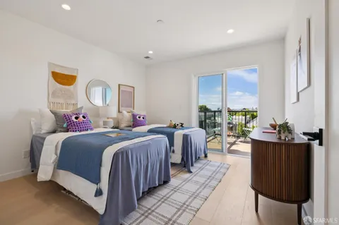 a bedroom with a bed and a potted plant