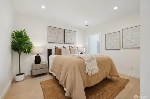 a kitchen with stainless steel appliances granite countertop a stove a sink dishwasher and a refrigerator with wooden cabinets