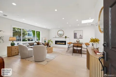 a living room with furniture a fireplace and a floor to ceiling window