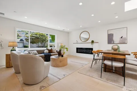 a living room with furniture a rug and a fireplace