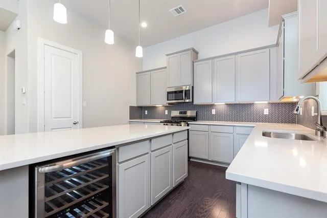 a kitchen that has a sink and a stove in it