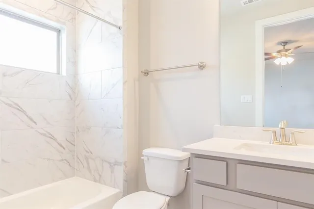 a white toilet sitting next to a bathroom sink