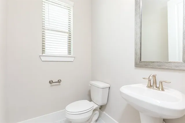 a bathroom with a sink a toilet and bathtub