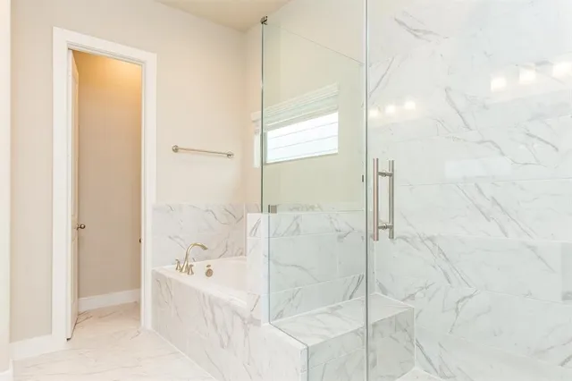 a bathroom with a tub sink and mirror