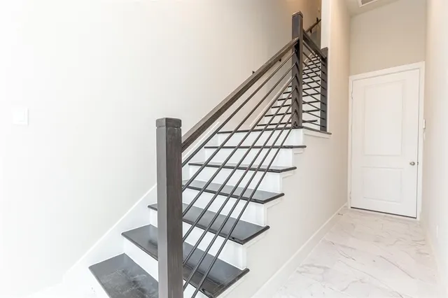 a view of staircase with white walls