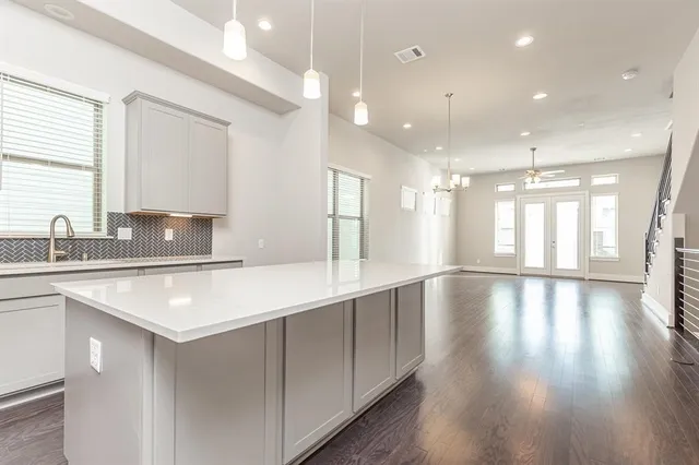 a view of a kitchen island wooden floor and a large window