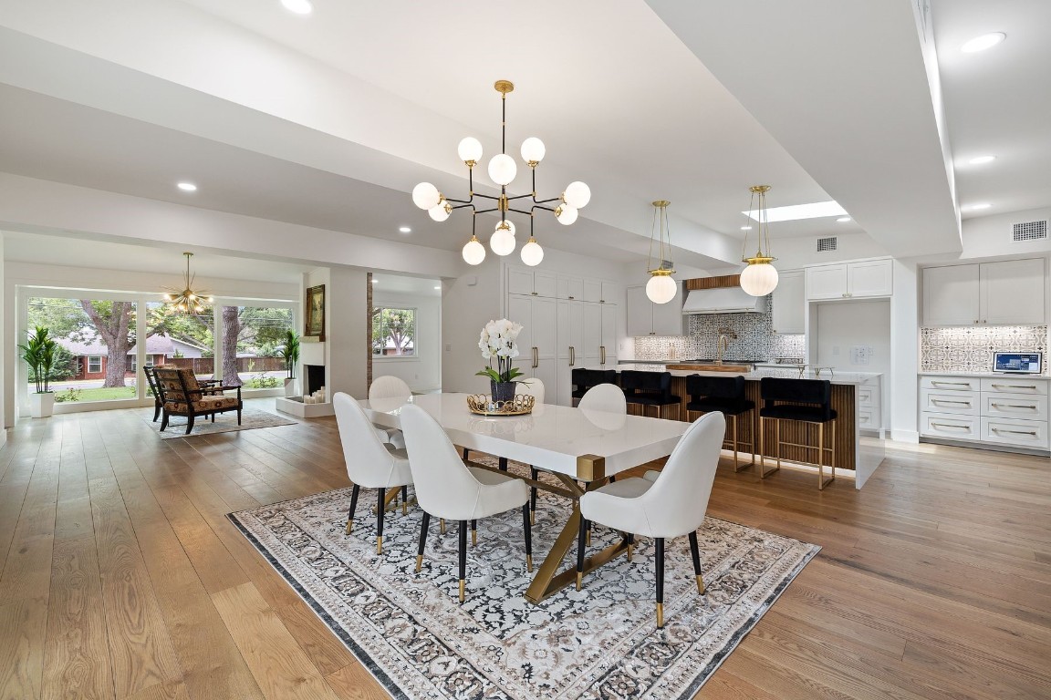 1503 East 15th Street Georgetown, TX 78626 - Photo 2 of 40 a dining room with wooden floor a chandelier a wooden table and chairs