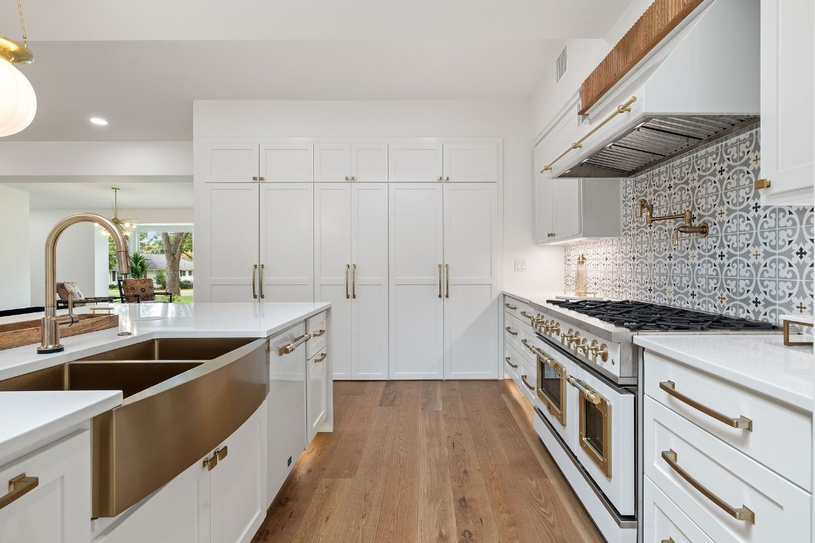 1503 East 15th Street Georgetown, TX 78626 - Photo 22 of 40 a kitchen with granite countertop a sink a counter top space stainless steel appliances and cabinets