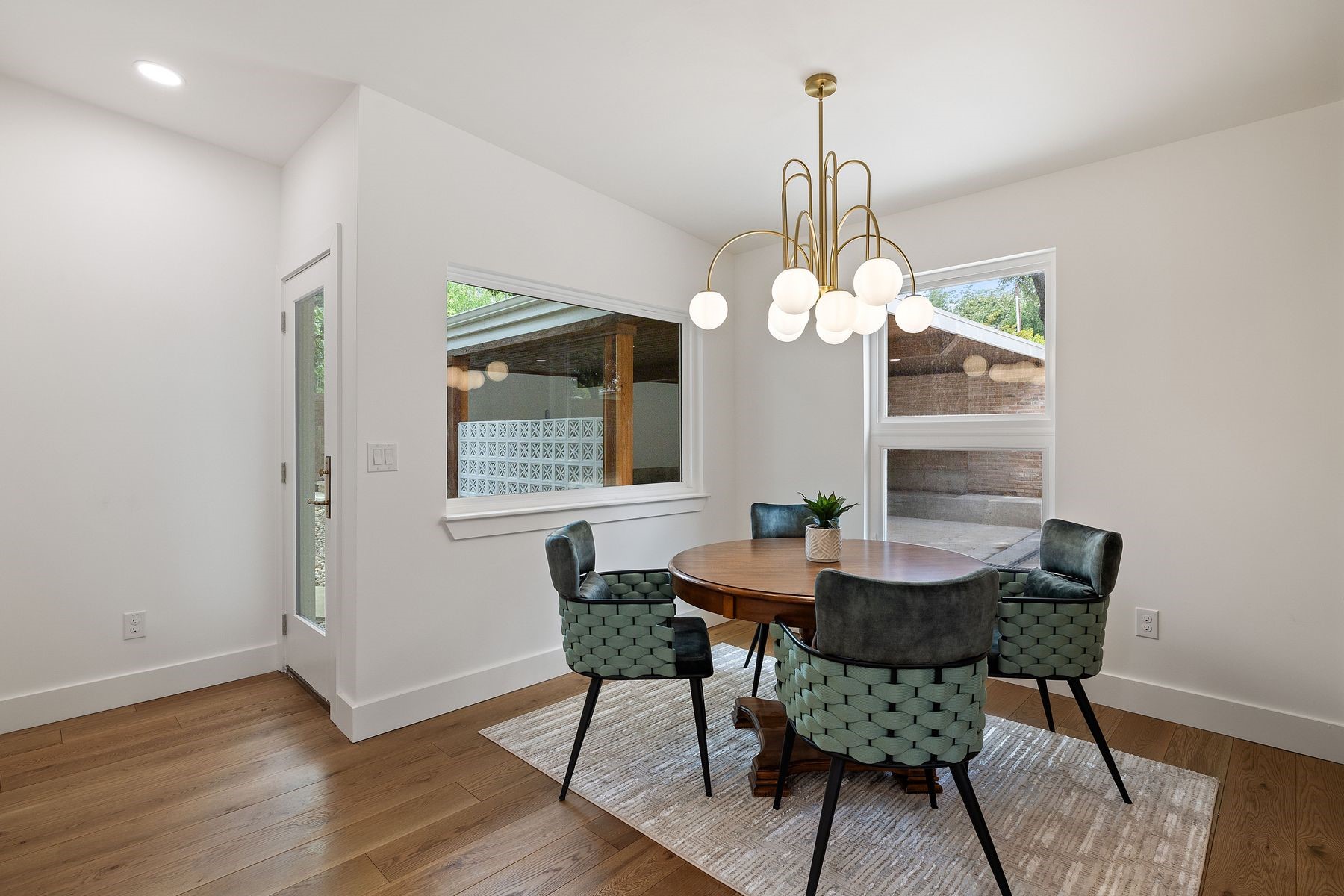 1503 East 15th Street Georgetown, TX 78626 - Photo 33 of 40 a dining room with wooden floor a chandelier a wooden table and chairs