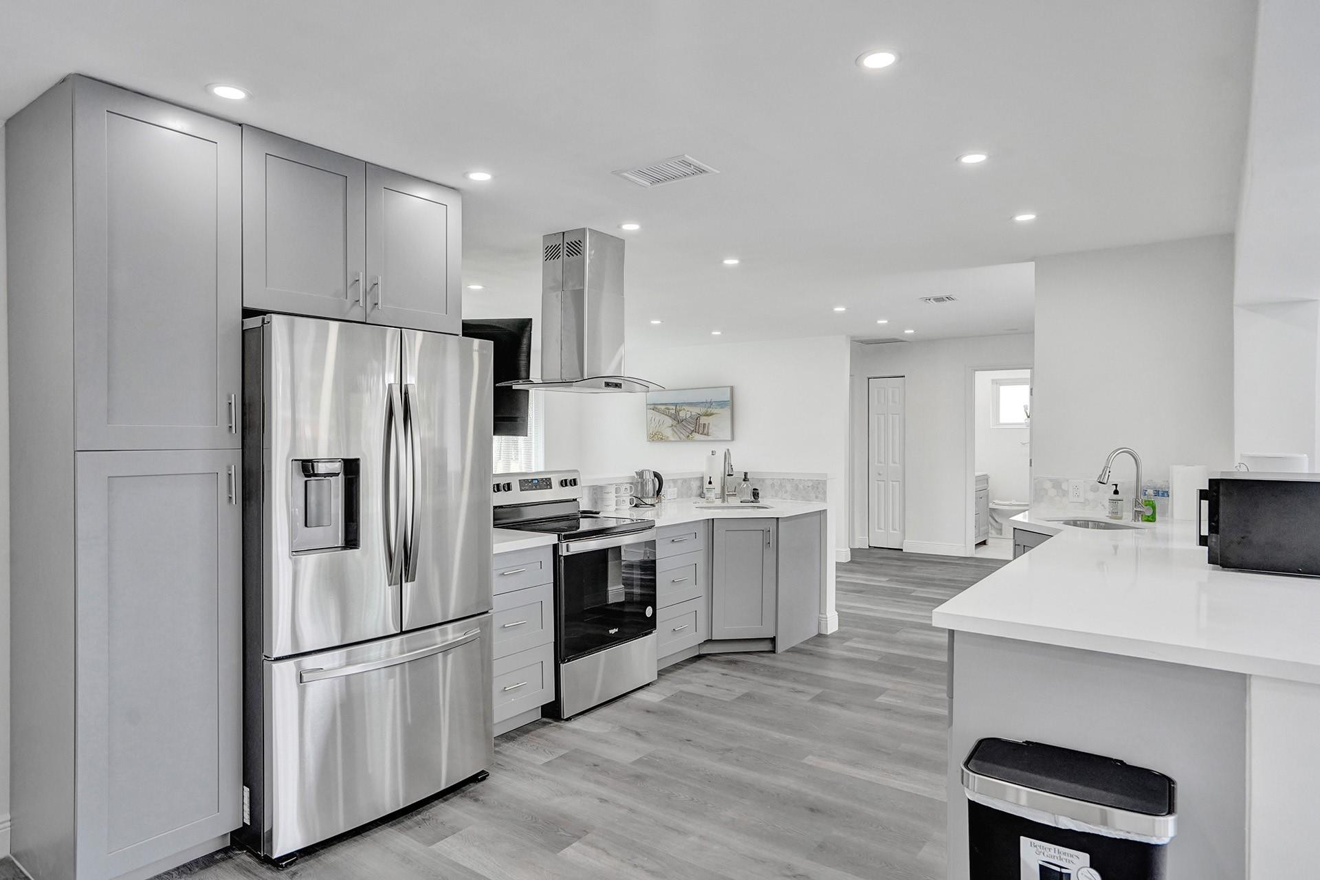 2114 North 42nd Avenue Hollywood, FL 33021 - Photo 8 of 24 a kitchen with stainless steel appliances a refrigerator stove microwave and cabinets