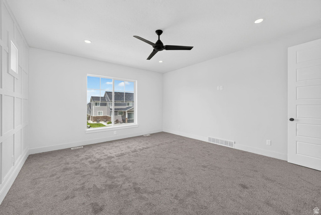 1002 West Temple Rim Lane Payson, UT 84651 - Photo 29 of 68 Carpeted room featuring a large window, a black ceiling fan, recessed lighting, and a paneled accent wall