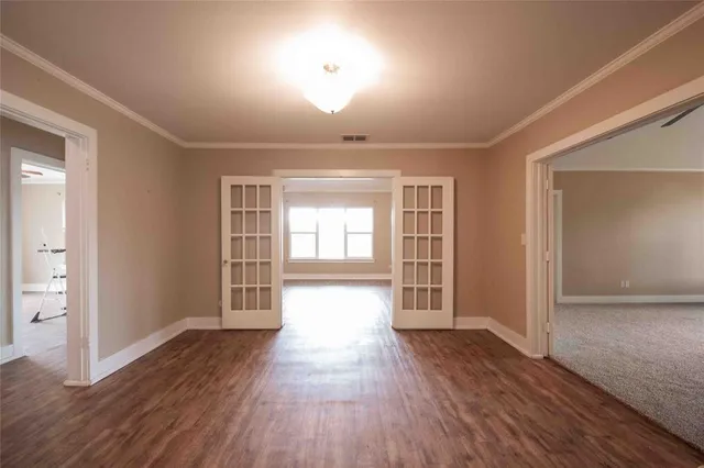 a view of room with window and wooden floor