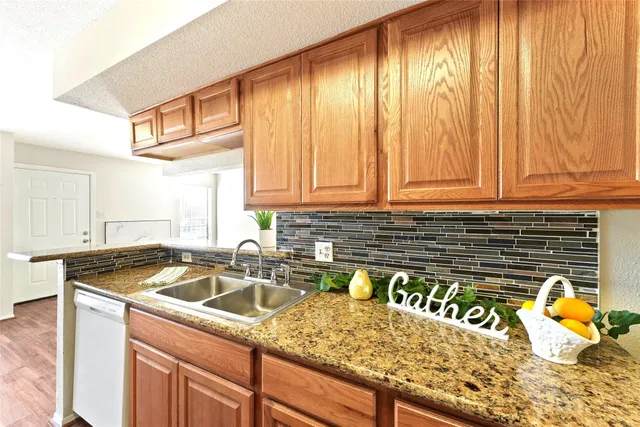 a kitchen with a sink a stove and cabinets