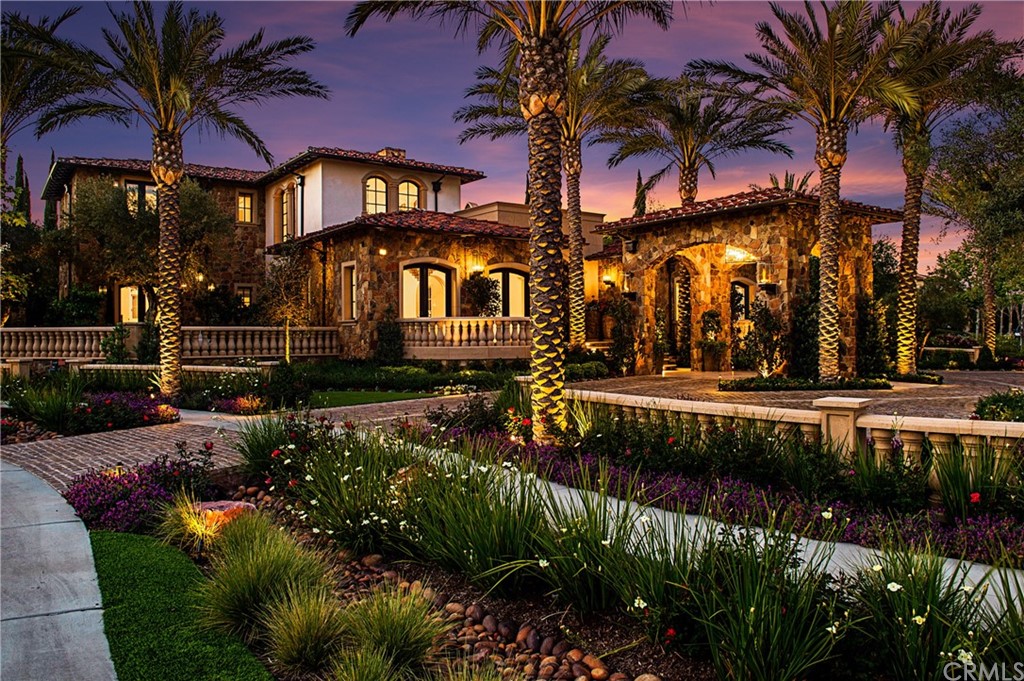 a front view of a house with a yard with yellow lighting