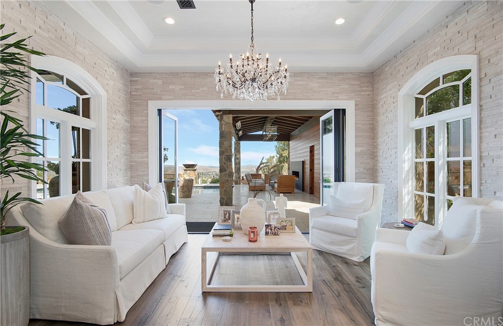 7 Rickie Lane Ladera Ranch, CA 92694 - Photo 11 of 36 a living room with furniture and a chandelier