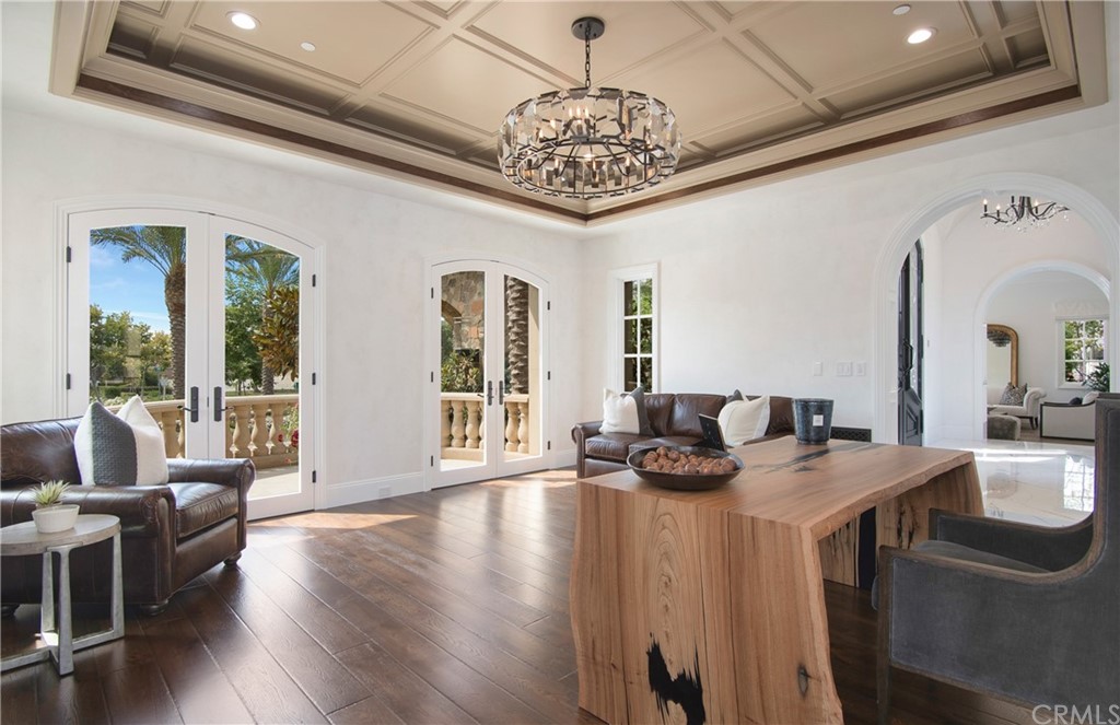 7 Rickie Lane Ladera Ranch, CA 92694 - Photo 15 of 36 a dining room with wooden floor a chandelier a wooden table and chairs