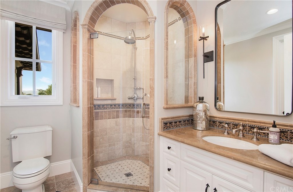 7 Rickie Lane Ladera Ranch, CA 92694 - Photo 28 of 36 a bathroom with a granite countertop sink a toilet and shower