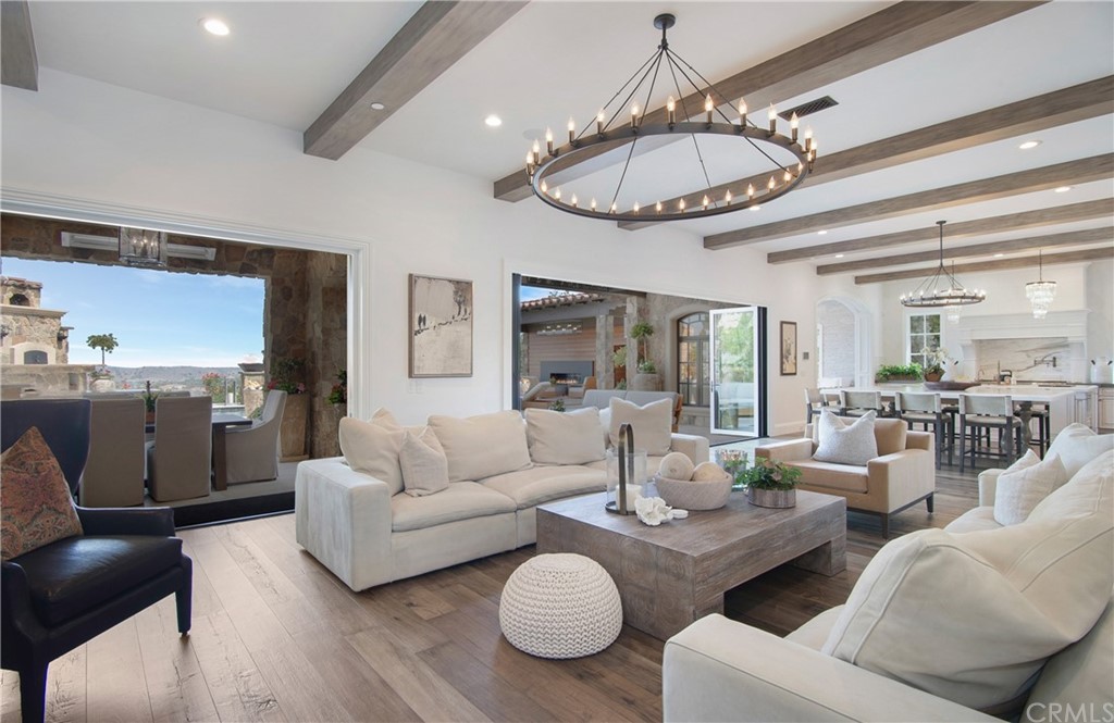 7 Rickie Lane Ladera Ranch, CA 92694 - Photo 5 of 36 a living room with furniture a dining table and a chandelier
