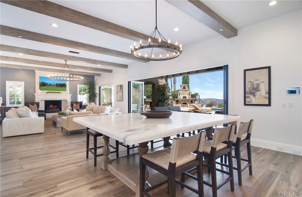 7 Rickie Lane Ladera Ranch, CA 92694 - Photo 7 of 36 a view of a dining room with furniture a chandelier and wooden floor