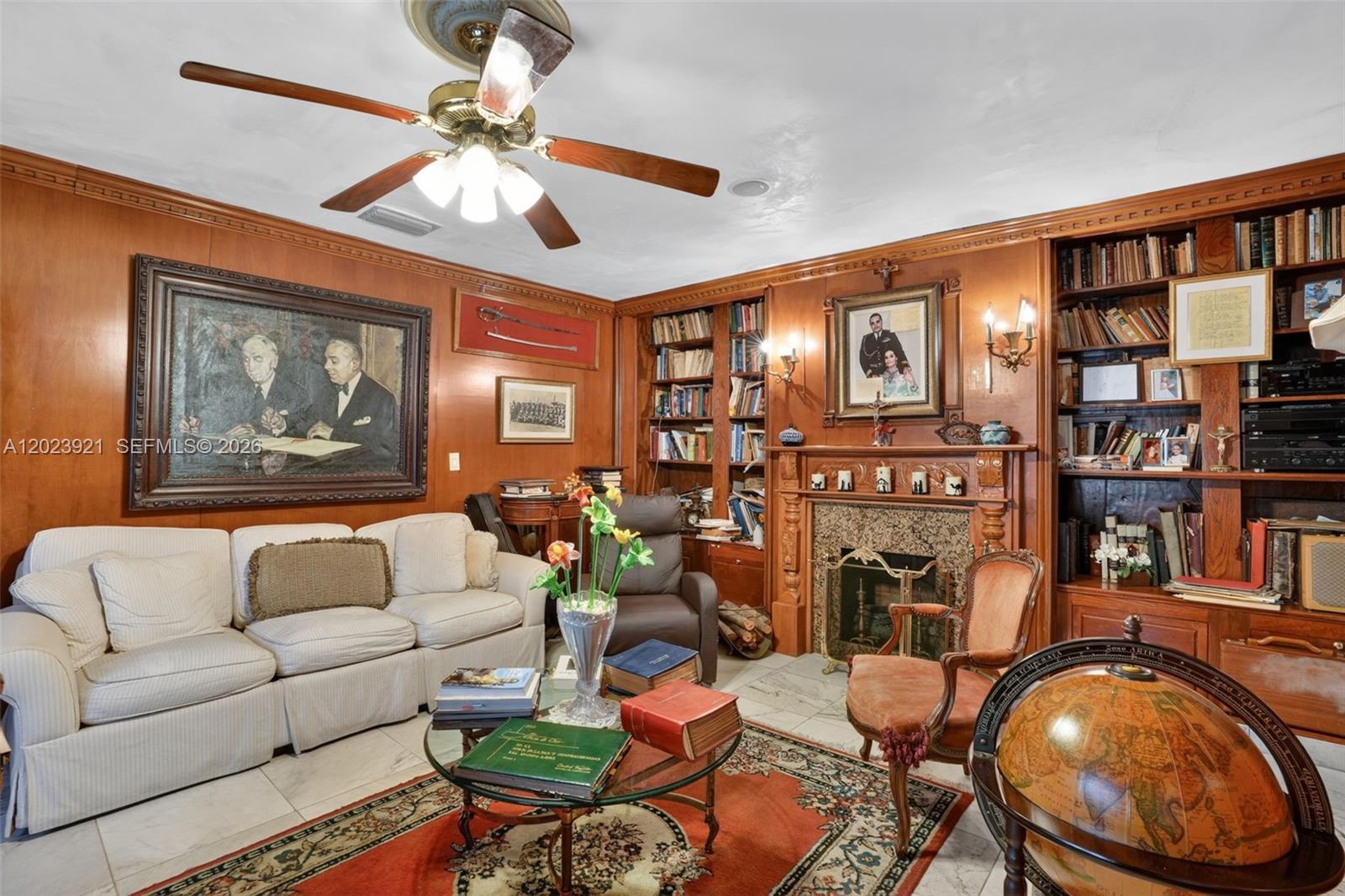 8461 Southwest 68th St Road Miami, FL 33143 - Photo 48 of 65 a living room with fireplace furniture and a book shelf