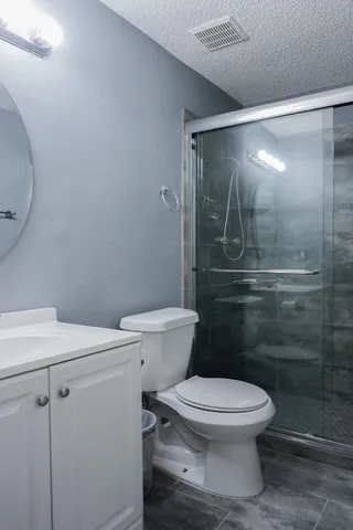 a white toilet sitting next to a shower