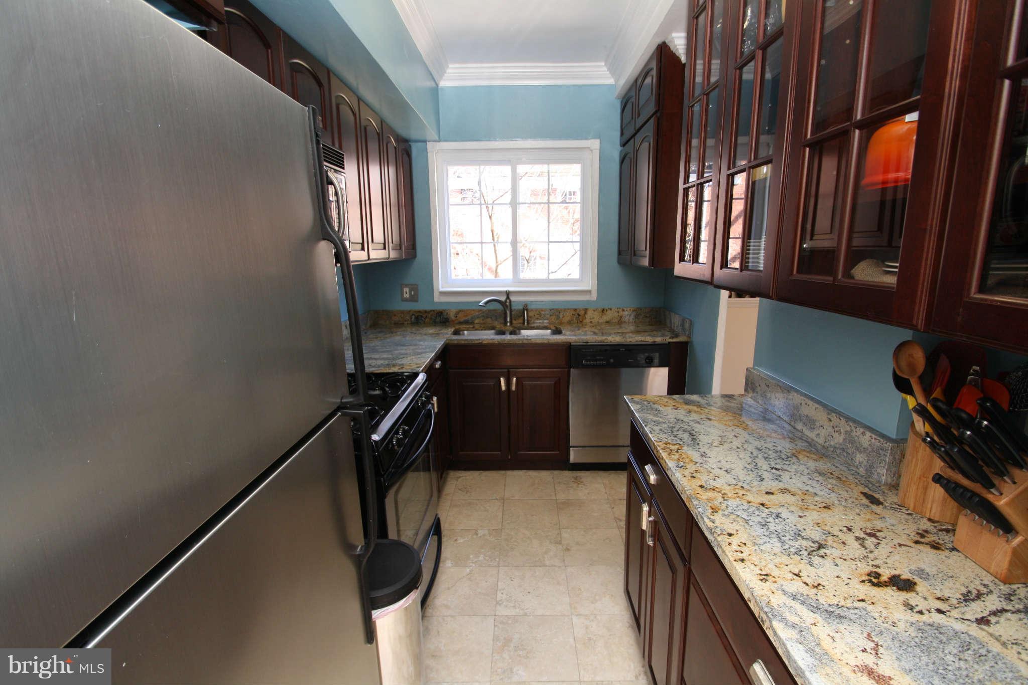 1634 Preston Road Alexandria, VA 22302 - Photo 8 of 19 a kitchen with granite countertop sink stove and cabinets
