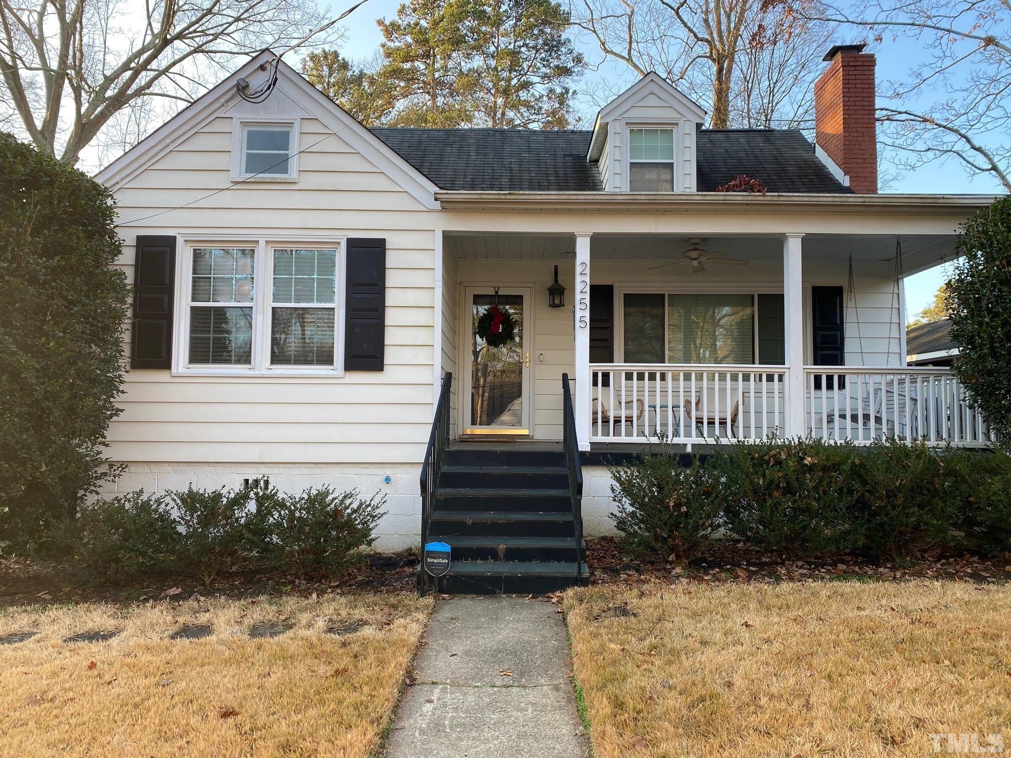 2255 The Circle Raleigh, NC 27608 - Photo 1 of 6 a view of a house with wooden fence and a large windows