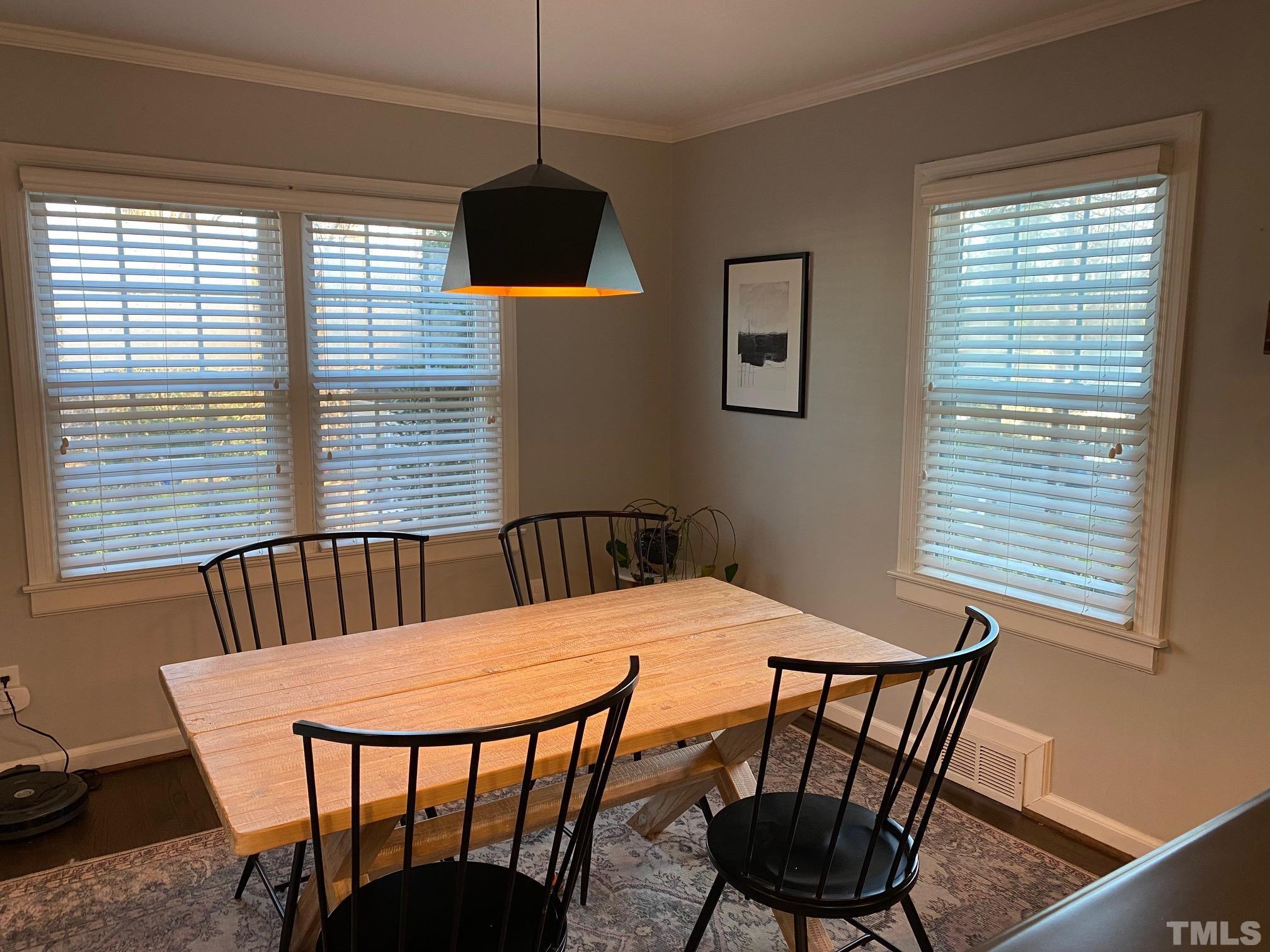 2255 The Circle Raleigh, NC 27608 - Photo 3 of 6 a view of a dining room with furniture and window
