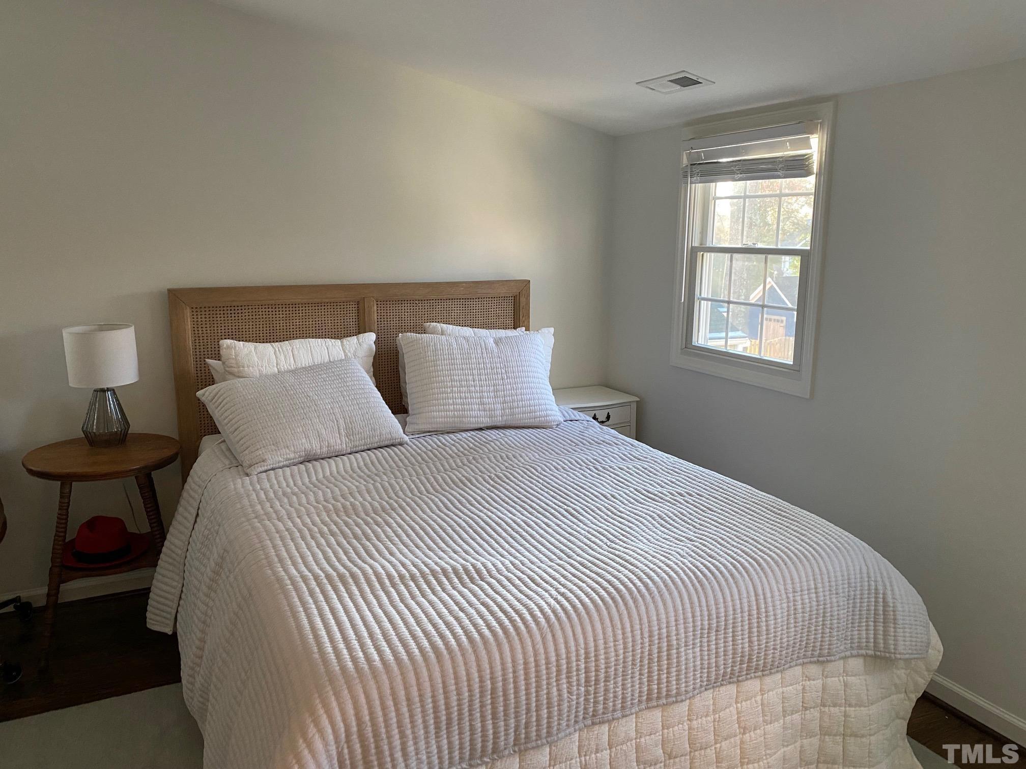 2255 The Circle Raleigh, NC 27608 - Photo 5 of 6 a bedroom with a bed and window
