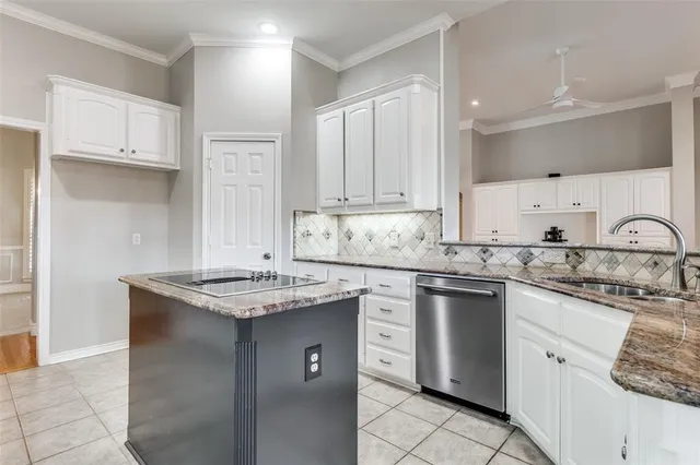 a kitchen with stainless steel appliances granite countertop a sink stove and cabinets