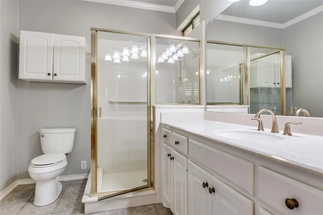 a bathroom with a granite countertop sink toilet a mirror and shower