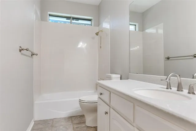 a bathroom with a sink toilet vanity and shower
