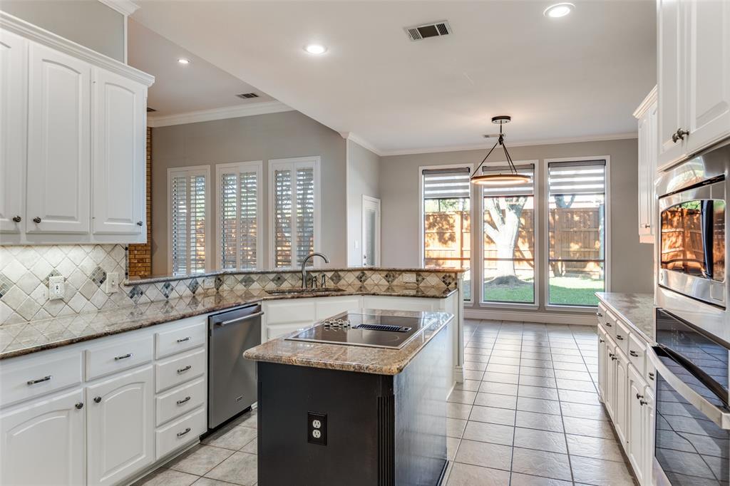 847 Turquoise Point Rockwall, TX 75032 - Photo 9 of 34 a large kitchen with kitchen island granite countertop a large window and white stainless steel appliances