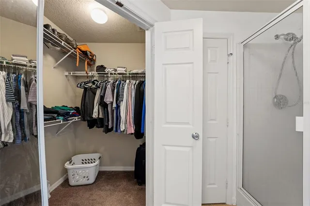 a bathroom with a granite countertop double vanity sink toilet and shower