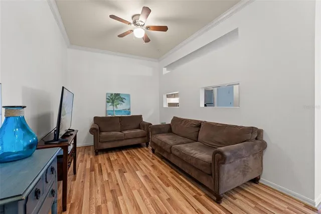 a living room with furniture kitchen view and a refrigerator