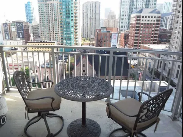 a view of a chairs and table in the balcony