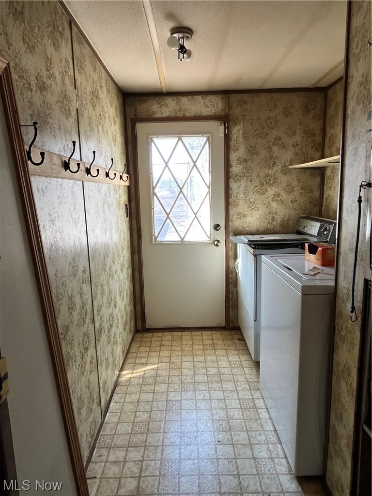 125 Porter Road Atwater, OH 44201 - Photo 7 of 22 Clothes washing area with washer and clothes dryer, a textured ceiling, and light tile floors