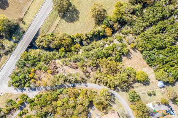 an aerial view of a houses with a yard