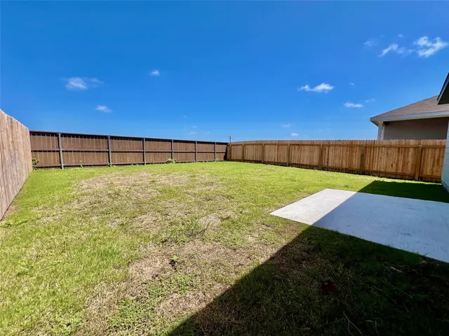 a view of an outdoor space with a wooden fence