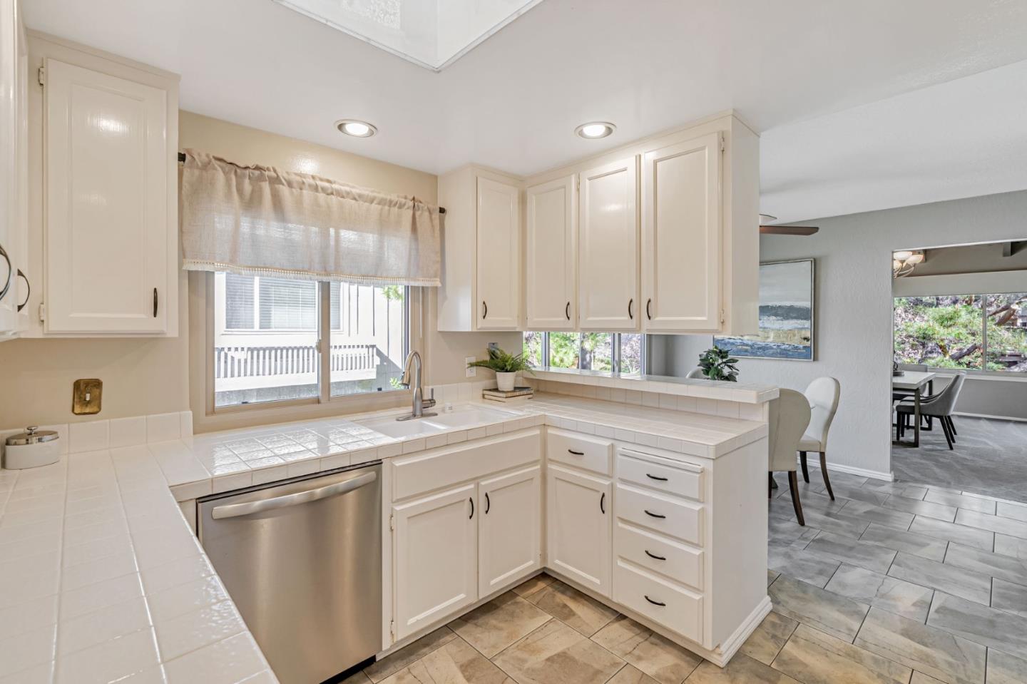 42 Weepingridge Court San Mateo, CA 94402 - Photo 12 of 45 a kitchen with white cabinets and white appliances
