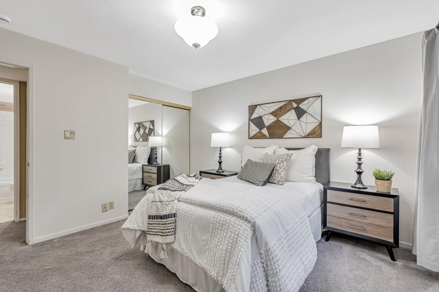 42 Weepingridge Court San Mateo, CA 94402 - Photo 21 of 45 a bedroom with a bed and a chandelier